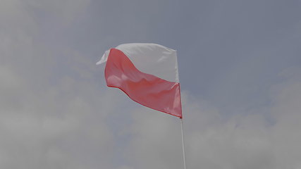 Image showing Poland flag on the flagpole waving in the wind against a blue sky with clouds. Slow motion