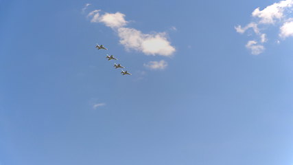 Image showing Four fighters Yak-130 fly in blue sky