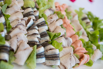 Image showing Delicious appetizer canapes on board for celebratory table