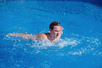 Image showing handsome boy swimming in outdoor pool