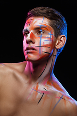 Image showing handsome young man with paint strokes on face