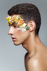 Image showing handsome young man with flowers on face