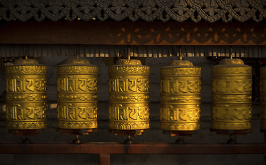 Image showing Rotating buddhist prayer wheels as symbol of buddhism religion