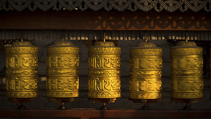 Image showing Rotating buddhist prayer wheels as symbol of buddhism religion