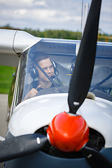 Image showing young man in small plane cockpit