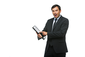 Image showing handsome businessman in suit with tablet