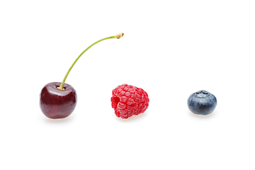 Image showing blueberry, cherry and raspberry berries isolated on white background