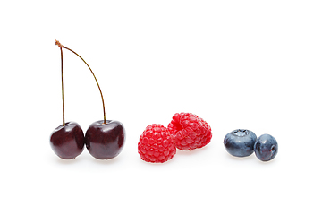 Image showing blueberry, cherry and raspberry berries isolated on white background