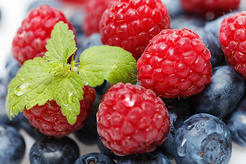 Image showing blueberry and raspberry berries isolated on white background