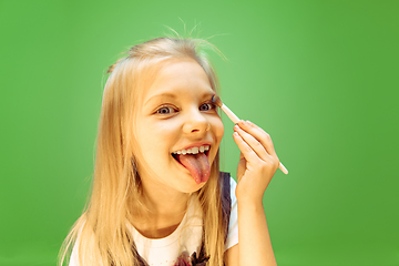 Image showing Little girl dreaming about future profession of makeup artist