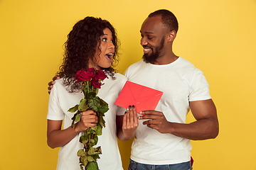 Image showing Valentine\'s day celebration, happy african-american couple isolated on yellow background