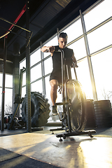 Image showing The male athlete training hard in the gym. Fitness and healthy life concept.