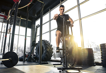 Image showing The male athlete training hard in the gym. Fitness and healthy life concept.