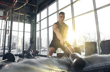 Image showing The male athlete training hard in the gym. Fitness and healthy life concept.