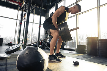 Image showing The male athlete training hard in the gym. Fitness and healthy life concept.