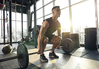 Image showing The male athlete training hard in the gym. Fitness and healthy life concept.