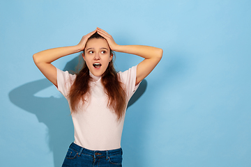 Image showing Caucasian teen girl portrait isolated on blue studio background