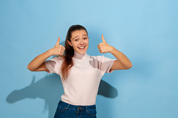 Image showing Caucasian teen girl portrait isolated on blue studio background