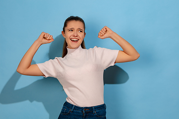 Image showing Caucasian teen girl portrait isolated on blue studio background