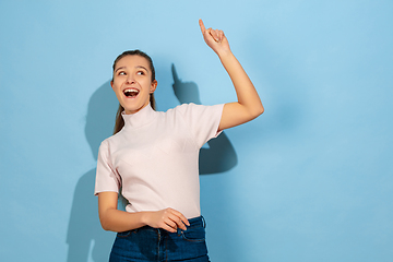 Image showing Caucasian teen girl portrait isolated on blue studio background