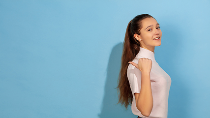 Image showing Caucasian teen girl portrait isolated on blue studio background