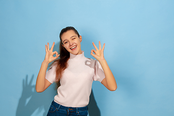 Image showing Caucasian teen girl portrait isolated on blue studio background