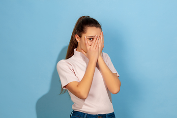 Image showing Caucasian teen girl portrait isolated on blue studio background