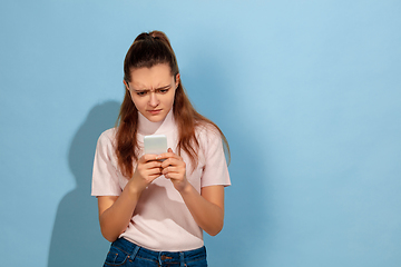 Image showing Caucasian teen girl portrait isolated on blue studio background