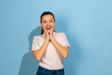 Image showing Caucasian teen girl portrait isolated on blue studio background