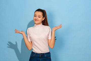 Image showing Caucasian teen girl portrait isolated on blue studio background