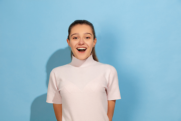 Image showing Caucasian teen girl portrait isolated on blue studio background