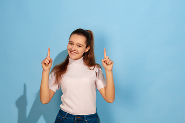 Image showing Caucasian teen girl portrait isolated on blue studio background