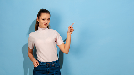 Image showing Caucasian teen girl portrait isolated on blue studio background