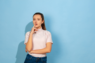 Image showing Caucasian teen girl portrait isolated on blue studio background