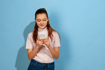 Image showing Caucasian teen girl portrait isolated on blue studio background