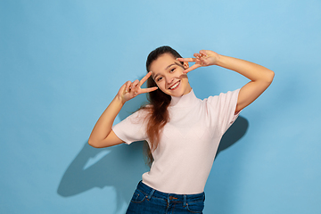 Image showing Caucasian teen girl portrait isolated on blue studio background