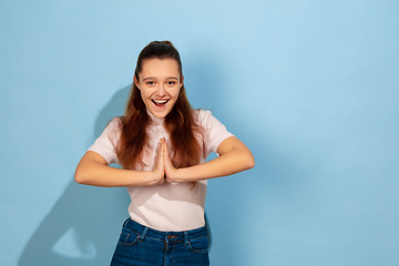 Image showing Caucasian teen girl portrait isolated on blue studio background