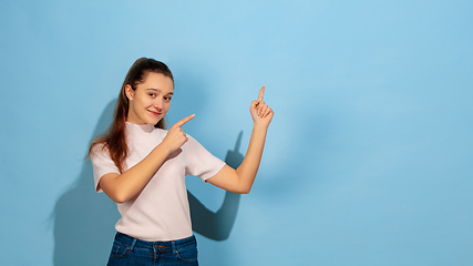 Image showing Caucasian teen girl portrait isolated on blue studio background