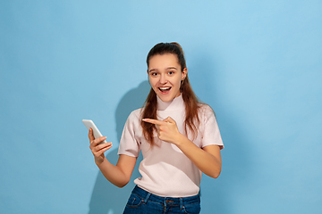 Image showing Caucasian teen girl portrait isolated on blue studio background