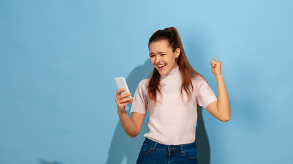 Image showing Caucasian teen girl portrait isolated on blue studio background