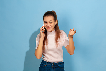 Image showing Caucasian teen girl portrait isolated on blue studio background