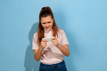 Image showing Caucasian teen girl portrait isolated on blue studio background