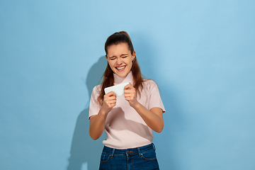 Image showing Caucasian teen girl portrait isolated on blue studio background