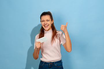 Image showing Caucasian teen girl portrait isolated on blue studio background