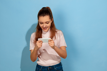 Image showing Caucasian teen girl portrait isolated on blue studio background