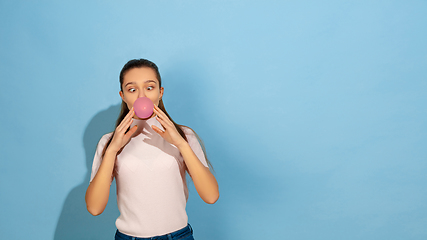 Image showing Caucasian teen girl portrait isolated on blue studio background