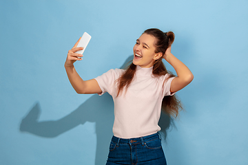 Image showing Caucasian teen girl portrait isolated on blue studio background