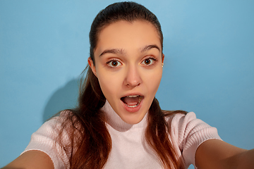 Image showing Caucasian teen girl portrait isolated on blue studio background