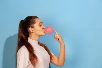 Image showing Caucasian teen girl portrait isolated on blue studio background