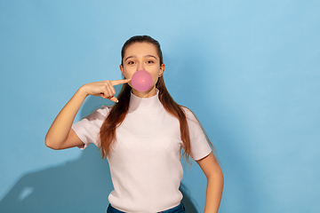 Image showing Caucasian teen girl portrait isolated on blue studio background